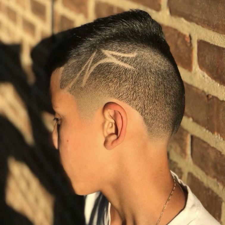 kids barber cut with a fade and design cut into the fade