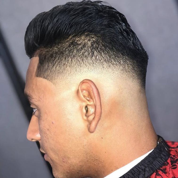 man looking to the left with a fresh fade