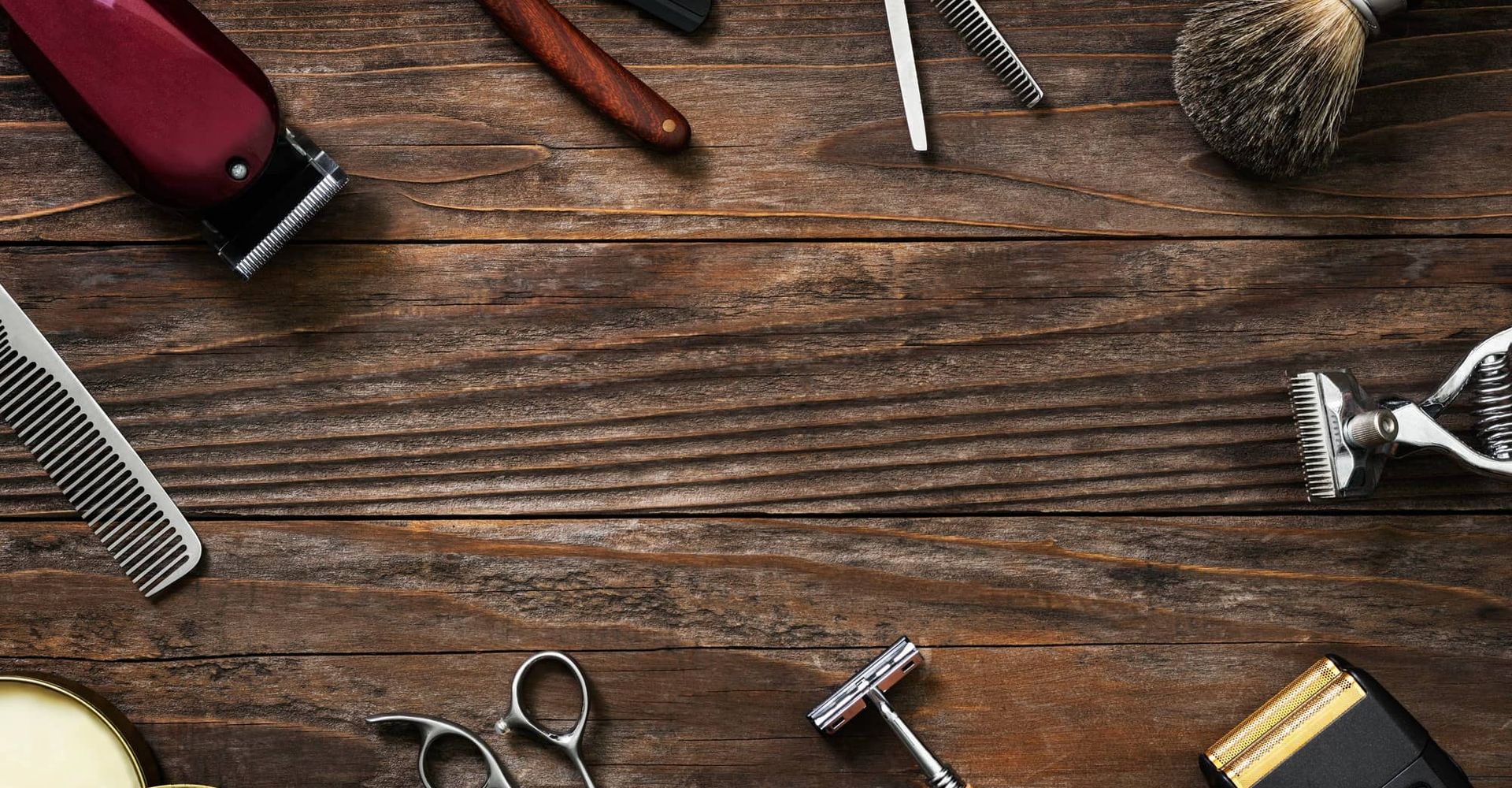 wood background surrounded by barber tools